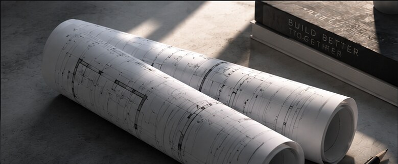 Rolled architectural drawing sets beside reference books